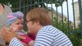 An inspired teenager plays with younger sister, he talks to her, touches feet Royalty Free Stock Photo