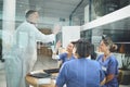 Inspired to keep improving their services. doctors giving each other a high five during a meeting in a hospital. Royalty Free Stock Photo