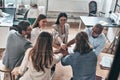 Inspired to work together. Top view of business colleagues holding hands on top of one another in a symbol of unity while working Royalty Free Stock Photo