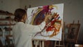 Inspired woman drawing in studio. Creative painter creating artwork indoor.