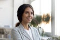 Inspired woman small business owner looking aside with happy smile