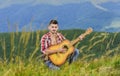 Inspiring environment. Man with guitar on top of mountain. Acoustic music. Summer music festival outdoors. Playing music Royalty Free Stock Photo