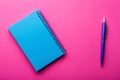 Inspiring Pink Workspace Blue Notebook and Pen Flat Lay for Educational or Office Design Projects Royalty Free Stock Photo