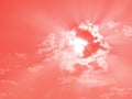 Sun through clouds, sunbeams, sky only, in trendy color of living coral Royalty Free Stock Photo