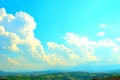 View from Loro Piceno at the sky with white clouds in golden light