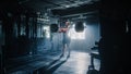 Inspiring Young Athlete Powerlifting and Exercising in a Deserted Hardcore Gym. A Future Female