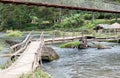 Instable old wooden bridge over a river Royalty Free Stock Photo