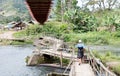 Instable old wooden bridge over a river Royalty Free Stock Photo