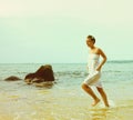 Instagram colorized vintage girl on beach portrait