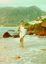 Instagram colorized vintage girl on beach portrait