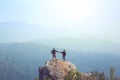 Instagram filter young man Asia tourist at mountain is watching over the misty and foggy morning sunrise