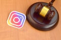 Instagram paper logo lies with wooden judge gavel. Entertainment lawsuit concept