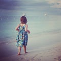 Instagram of younf girl walking along tropical beach