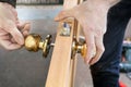 Install interior door, joiner mount knob with lock, hand close-up. Royalty Free Stock Photo