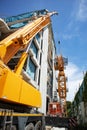 install a tower crane at the construction site by using a mobile crane for lifting and assembly Royalty Free Stock Photo