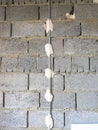 Installation of beacons for plaster walls. The wall of expanded clay blocks with installed beacons is ready for plaster Royalty Free Stock Photo