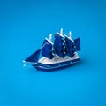 Installation of a blue yacht with sails on a blue background Royalty Free Stock Photo