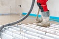 installation of concrete and anhydrite on underfloor heating in a room of a newly built family house