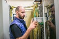Installation of a database server in a rack with computer equipment. The engineer performs the work on replacing the server