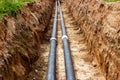 Installation of the distribution unit of heating and water supply network. Frame for connecting pipes in the trench of ground. Royalty Free Stock Photo
