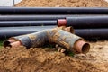 Installation of the distribution unit of heating and water supply network. Frame for connecting pipes in the trench of ground. Royalty Free Stock Photo