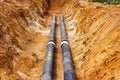 Installation of the distribution unit of heating and water supply network. Frame for connecting pipes in the trench of ground. Royalty Free Stock Photo