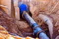 Installation of the distribution unit of heating and water supply network. Frame for connecting pipes in the trench of ground. Royalty Free Stock Photo