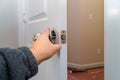 Installation locked interior door woodworker hands install lock Royalty Free Stock Photo