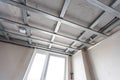 Installation of drywall. Workers are using screws and a screwdriver to attach plasterboard to the ceiling Royalty Free Stock Photo