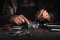 Installation of an electrical cable or wire in a gray junction box by the hands of a master electrician Royalty Free Stock Photo