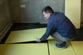 Installation of expanded polystyrene for floor insulation.