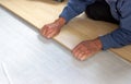 Installation of flooring, a worker mounts a laminated board