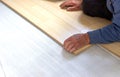 Installation of flooring, a worker mounts a laminated board