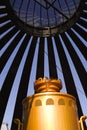 Installation in the form of a lattice structure in a city park. A hut made of metal elements with a large kettle inside. Royalty Free Stock Photo