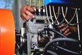 Installation of a fuel pump for a diesel engine after repair on an adjustment stand in a workshop, repair of a fuel pump, Royalty Free Stock Photo