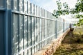 Installation of gray fence from metal profile