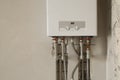 Installation of home gas heating boiler with red taps