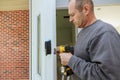 Installation interior door woodworker hands install lock Royalty Free Stock Photo