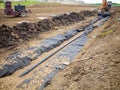 Installation of a leachate collection system under a new landfill with a liner and perforated rock. Royalty Free Stock Photo