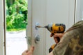 Installation locked interior door knobs, close-up woodworker hands install lock. Royalty Free Stock Photo