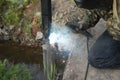 Installation of a metal column using a welding machine