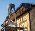 Installation of metal drain on the roof of the house