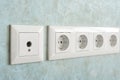 Installation of modern power and television sockets on a wall close-up.