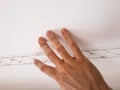 Installation of mouldings on the ceiling of the refurbished room. Fragment of molding, top view of the ceiling with pre-scraping