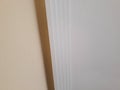 Installation of mouldings on the ceiling of the refurbished room. Molding fragment, top view of the molding at the corner angle.