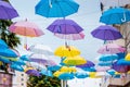 Installation of multicolored umbrellas on the street of a modern