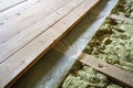 Installation of new floor of wooden natural planks and mineral wool insulation for isolation and keeping warmth. Modern technologi Royalty Free Stock Photo