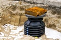 Installation of a new modern plastic rainwater drainage well with cast iron grate in the city street