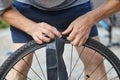 Hands insert camera into tire wheel bicycle