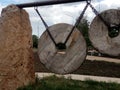 installation in the park in the form of large stone millstones on steel chains